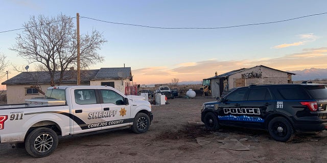 In this photo released by the Colorado Bureau of Investigation, law enforcement vehicles are parked at one of two properties where skeletal remains were found about 20 miles south-southeast of Alamosa, Colo., on Wednesday, Nov. 18, 2020. (Colorado Bureau of Investigation via AP)