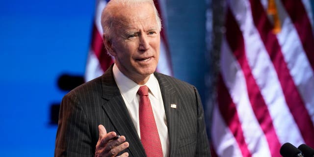 President-elect Joe Biden, accompanied by Vice President-elect Kamala Harris, speaks at The Queen theater, Thursday, Nov. 19, 2020, in Wilmington, Del. Biden embraced an end to cash bail during the presidential campaign, and ran on a Democratic platform that favored ending cash bail after the idea was not included in the party's 2016 platform. (AP Photo/Andrew Harnik)