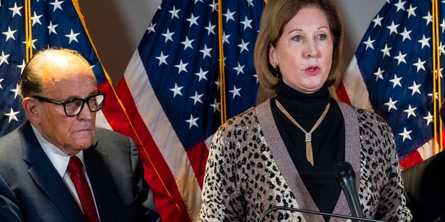 Sidney Powell, right, speaks next to former Mayor of New York Rudy Giuliani, as members of President Donald Trump's legal team, during a news conference.