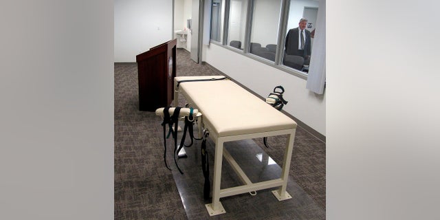This Oct. 20, 2011, file photo shows the execution chamber at the Idaho Maximum Security Institution as Warden Randy Blades looks on in Boise, Idaho.