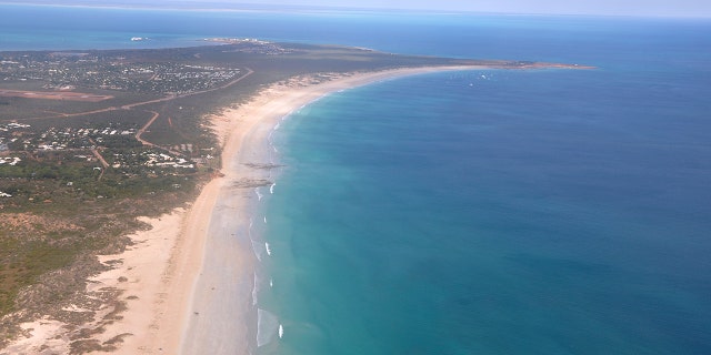 This aerial photo shows Cable Beach and the town of Broome, Western Australia, on June 24, 2014. A 55-year-old man died Sunday, Nov. 22, 2020 after being attacked by a shark off Cable Beach, a popular tourist spot on Australia’s Indian Ocean coast, the eighth fatality in the country this year. (Kim Christian/AAP Image via AP)