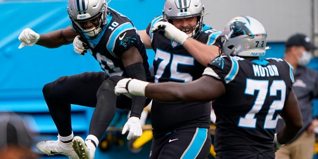 Carolina Panthers wide receiver Curtis Samuel, left, celebrates after scoring with Michael Schofield and Taylor Moton during the second half of an NFL football game against the Detroit Lions Sunday, Nov. 22, 2020, in Charlotte, N.C. (AP Photo/Brian Blanco)