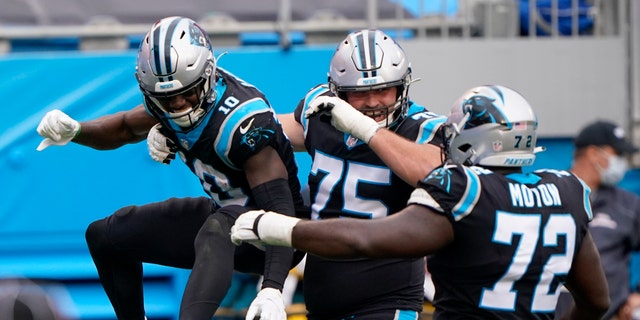 Carolina Panthers wide receiver Curtis Samuel, left, celebrates after scoring with Michael Schofield and Taylor Moton during the second half of an NFL football game against the Detroit Lions Sunday, Nov. 22, 2020, in Charlotte, N.C. (AP Photo/Brian Blanco)