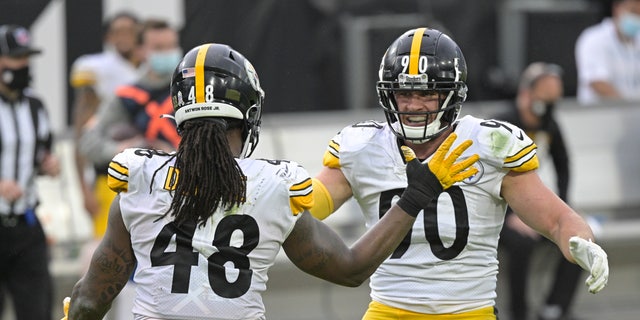 Pittsburgh Steelers linebacker Bud Dupree (48) and linebacker T.J. Watt, right, celebrate a big play against the Jacksonville Jaguars during the second half of an NFL football game, Sunday, Nov. 22, 2020, in Jacksonville, Fla. (AP Photo/Phelan M. Ebenhack)