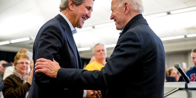 FILE - In this Feb. 1, 2020, President Joe Biden smiles as climate czar John Kerry, left, takes the podium to speak at a campaign stop at the South Slope Community Center in North Liberty, Iowa. (AP Photo/Andrew Harnik, File)