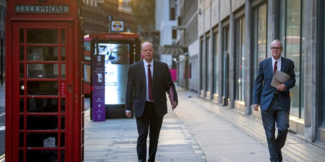 Britain's Chief medical officer Chris Whitty and chief scientific adviser Sir Patrick Vallance walk together on Victoria Street in Westminster, London, as England continues a four-week national lockdown to curb the spread of coronavirus, Tuesday, Nov. 24, 2020. (Victoria Jones/PA via AP)