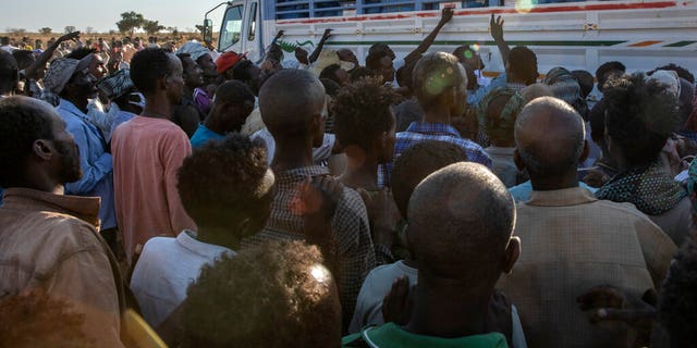 Tigray refugees who fled the conflict in Ethiopia's Tigray region, wait to receive aid at Umm Rakouba refugee camp in Qadarif, eastern Sudan, Tuesday, Nov. 24, 2020. (AP Photo/Nariman El-Mofty)