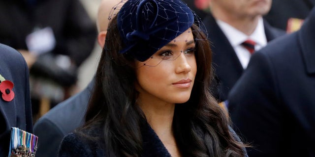 In this Thursday, Nov. 7, 2019 file photo Meghan the Duchess of Sussex stands after she and her husband Britain's Prince Harry placed a Cross of Remembrance as they attend the official opening of the annual Field of Remembrance at Westminster Abbey in London. The Duchess of Sussex has revealed that she had a miscarriage in July. Meghan described the experience in an opinion piece in the New York Times. She wrote: "I knew, as I clutched my firstborn child, that I was losing my second." The pair share a son named Archie, born in 2019. 