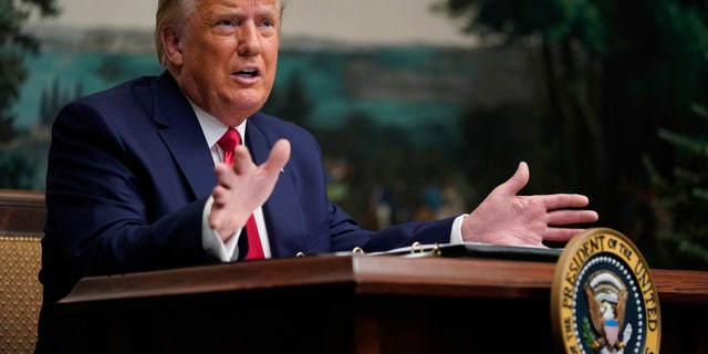 President Donald Trump speaks with reporters after participating in a video teleconference with members of the military on Thanksgiving Thursday, November 26, 2020, at the White House in Washington.  (AP Photo / Patrick Semansky)