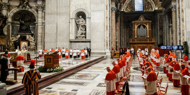 A consistory ceremony where 13 bishops were elevated to a cardinal's rank in St. Peter’s Basilica at the Vatican, Saturday, Nov. 28, 2020. (Fabio Frustaci/POOL via AP)