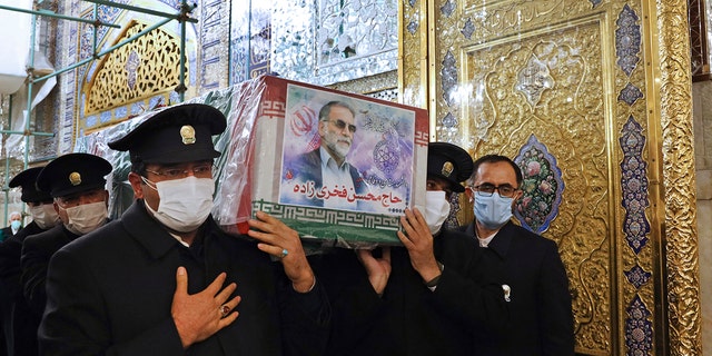 In this picture released by the Iranian Defense Ministry and taken on Saturday, Nov. 28, 2020, caretakers from the Imam Reza holy shrine, carry the flag draped coffin of Mohsen Fakhrizadeh, an Iranian scientist linked to the country's disbanded military nuclear program, who was killed on Friday, during a funeral ceremony in the northeastern city of Mashhad, Iran. An opinion piece published by a hard-line Iranian newspaper has suggested that Iran must attack the Israeli port city of Haifa if Israel carried out the killing of a scientist. (Iranian Defense Ministry via AP)