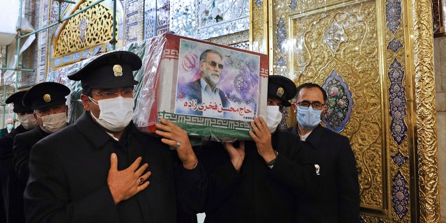 In this picture released by the Iranian Defense Ministry and taken on Saturday, Nov. 28, 2020, caretakers from the Imam Reza holy shrine, carry the flag draped coffin of Mohsen Fakhrizadeh, an Iranian scientist linked to the country's disbanded military nuclear program, who was killed on Friday, during a funeral ceremony in the northeastern city of Mashhad, Iran. An opinion piece published by a hard-line Iranian newspaper has suggested that Iran must attack the Israeli port city of Haifa if Israel carried out the killing of a scientist. (Iranian Defense Ministry via AP)