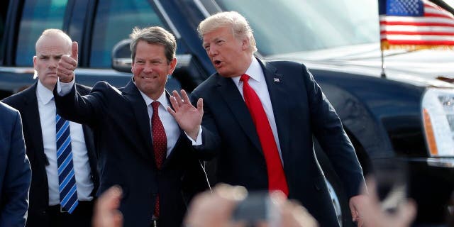 FILE - In this Nov. 4, 2018, file photo, then-Georgia Republican gubernatorial candidate Brian Kemp, left, walks with President Donald Trump as Trump arrives for a rally in Macon , Ga. President Trump said Sunday, Nov. 29, 2020 he was "ashamed" for endorsing the Republican governor of Georgia after he lost in the state to Democrat Joe Biden. Trump said on Fox News that Gov. Brian Kemp has "done absolutely nothing" to question the state’s results.. (AP Photo/John Bazemore, File)