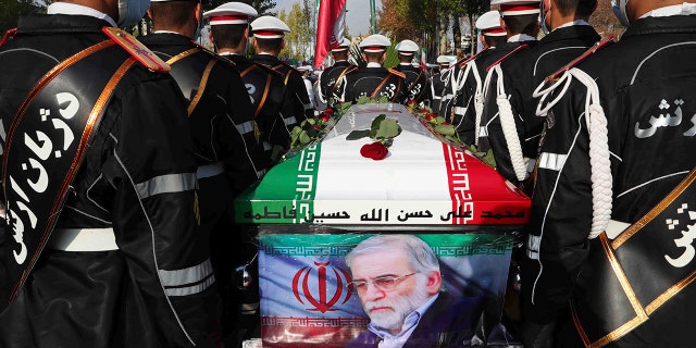 In this photo released by the official Iranian Ministry of Defense website, soldiers stand near the flag-draped coffin of Mohsen Fakhrizadeh, a scientist who was killed on Friday, during a funeral ceremony in Tehran, Iran, on Friday. Monday, November 30.  2020. (Iranian Ministry of Defense via AP)