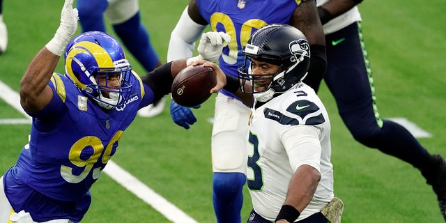 Seattle Seahawks quarterback Russell Wilson (3) throws under pressure from Los Angeles Rams defensive end Aaron Donald (99) during the second half of an NFL football game Sunday, Nov. 15, 2020, in Inglewood, Calif. (AP Photo/Jae C. Hong)
