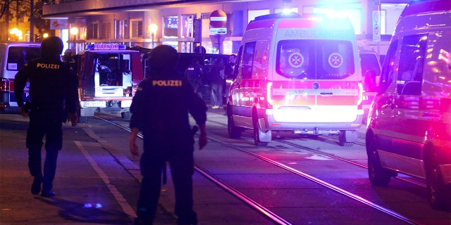 A police officer walked near an ambulance at the scene after gunfire in Vienna on Monday. (Photo / Ronald Zak)