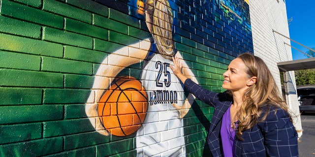 Becky Hammon visits a mural in San Antonio.