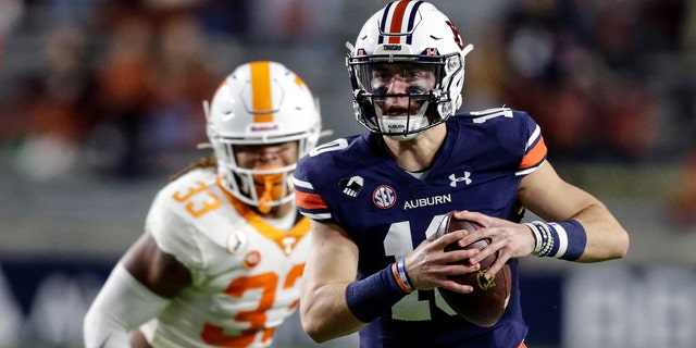 Auburn quarterback Bo Nix (10) scrambles during the first half of the team's NCAA college football game against Tennessee on Saturday, Nov. 21, 2020, in Auburn, Ala. (AP Photo/Butch Dill)