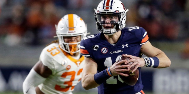 Auburn quarterback Bo Nix (10) scrambles during the first half of the team's NCAA college football game against Tennessee on Saturday, Nov. 21, 2020, in Auburn, Ala. (AP Photo/Butch Dill)