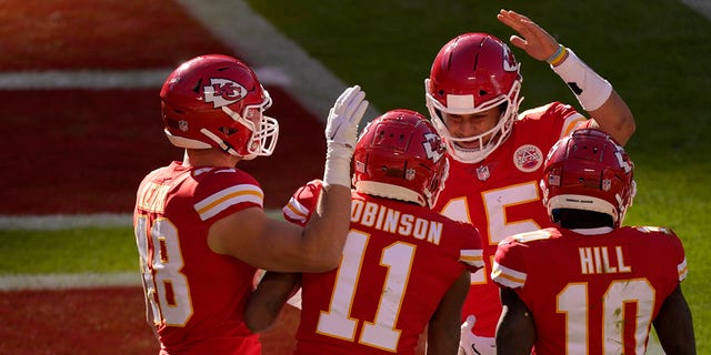 Kansas City Chiefs' Nick Keizer (48), Demarcus Robinson (11), Tyreek Hill (10) and Patrick Mahomes (15), celebrate a touchdown scored on a catch by Robinson in the second half of an NFL football game agains the New York Jets on Sunday, Nov. 1, 2020, in Kansas City, Mo. (AP Photo/Charlie Riedel)