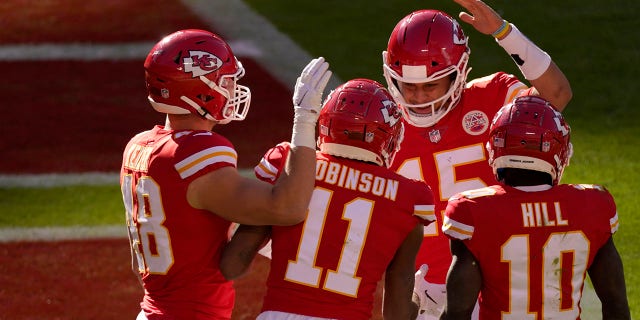 Kansas City Chiefs' Nick Keizer (48), Demarcus Robinson (11), Tyreek Hill (10) and Patrick Mahomes (15), celebrate a touchdown scored on a catch by Robinson in the second half of an NFL football game agains the New York Jets on Sunday, Nov. 1, 2020, in Kansas City, Mo. (AP Photo/Charlie Riedel)