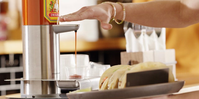 Cholula claims to have developed “the world’s first hands-free hot sauce dispenser.”