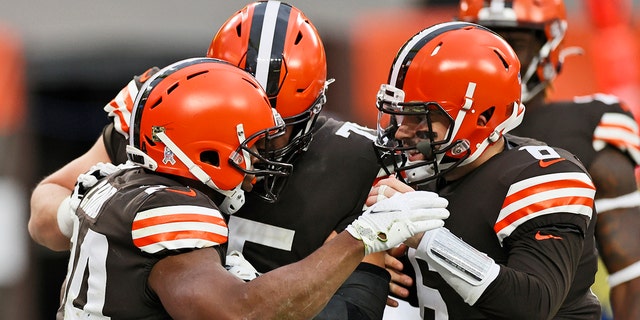 Cleveland Browns quarterback Baker Mayfield, right, congratulates running back Nick Chubb, left, after Chubb rushed for a 9-yard touchdown during the second half of an NFL football game against the Houston Texans, Sunday, Nov. 15, 2020, in Cleveland. (AP Photo/Ron Schwane)