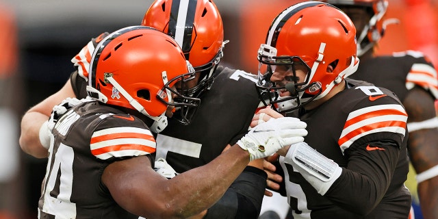 Cleveland Browns quarterback Baker Mayfield, right, congratulates running back Nick Chubb, left, after Chubb rushed for a 9-yard touchdown during the second half of an NFL football game against the Houston Texans, Sunday, Nov. 15, 2020, in Cleveland. (AP Photo/Ron Schwane)