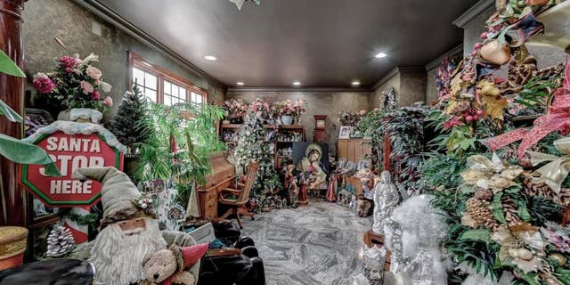 The Christmas decor starts in the foyer and overflows into the room to the left of the foyer (pictured). (Courtesy of Robert DeFalco Realty/Guy Argenzio of Realty Photo Media)