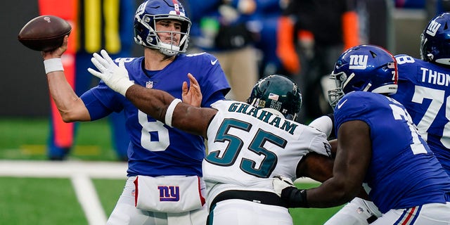 New York Giants quarterback Daniel Jones (8) looks to throw a pass as Philadelphia Eagles' Brandon Graham (55) rushes him during the first half of an NFL football game Sunday, Nov. 15, 2020, in East Rutherford, N.J. (AP Photo/Seth Wenig)