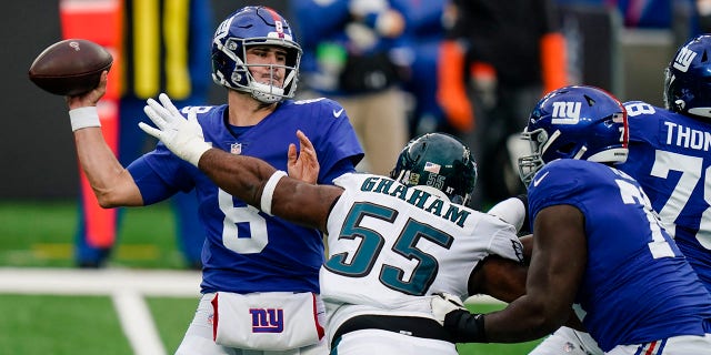 New York Giants quarterback Daniel Jones (8) looks to throw a pass as Philadelphia Eagles' Brandon Graham (55) rushes him during the first half of an NFL football game Sunday, Nov. 15, 2020, in East Rutherford, N.J. (AP Photo/Seth Wenig)