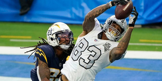 Las Vegas Raiders tight end Darren Waller (83) hauls in a touchdown pass as Los Angeles Chargers strong safety Rayshawn Jenkins defends second half of an NFL football game Sunday, Nov. 8, 2020, in Inglewood, Calif. (AP Photo/Alex Gallardo)