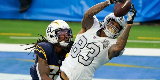 Las Vegas Raiders tight end Darren Waller (83) hauls in a touchdown pass as Los Angeles Chargers strong safety Rayshawn Jenkins defends second half of an NFL football game Sunday, Nov. 8, 2020, in Inglewood, Calif. (AP Photo/Alex Gallardo)