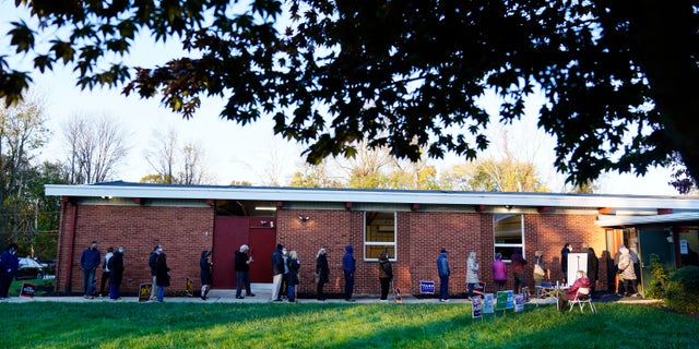 People line up outside a polling place to vote in the 2020 general election Tuesday, Nov. 3, 2020, in Springfield, Pa. (AP Photo/Matt Slocum)