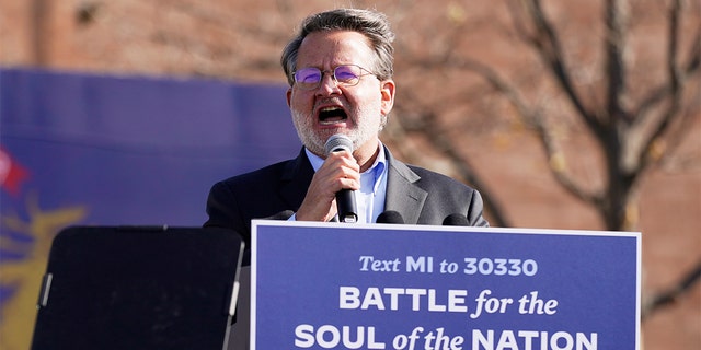 Sen. Gary Peters, D-Mich., speaks at a rally for Democratic presidential candidate Joe Biden, the former vice president, at Northwestern High School in Flint, Mich., Oct. 31, 2020. 