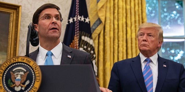 U.S. Defense Secretary Mark Esper speaks after he was sworn in as President Trump looks on in the Oval Office at the White House in Washington, D.C., July 23, 2019. 