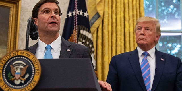 U.S. Defense Secretary Mark Esper speaks after he was sworn in as President Trump looks on in the Oval Office at the White House in Washington, D.C., July 23, 2019.