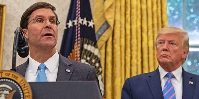 US Defense Secretary Mark Esper speaks after he was sworn in as President Donald Trump looks on in the Oval Office at the White House in Washington, DC, on July 23, 2019. - The Senate Tuesday voted overwhelmingly 90 to 8 to confirm President Donald Trump's pick for secretary of defense, Mark Esper, giving the Pentagon its first permanent chief since James Mattis stepped down in January. 