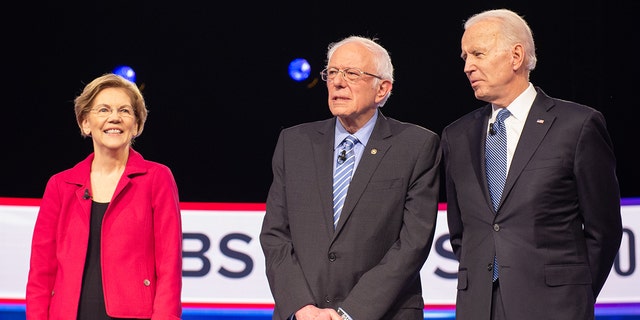 2020 presidential candidates Senator Elizabeth Warren, Democrat of Massachusetts, left, Senator Bernie Sanders, Independent from Vermont, and former Vice President Joe Biden, arrive on stage ahead of the Democratic presidential debate in Charleston, Carolina South, in February 2020. Photographer: Alice Keeney / Bloomberg via Getty Images