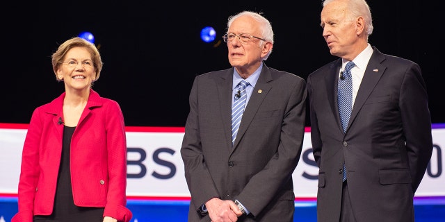 2020 presidential candidates Senator Elizabeth Warren, a Democrat from Massachusetts, left, Senator Bernie Sanders, an Independent from Vermont, and President Joe Biden, arrive on stage ahead of the Democratic presidential debate in Charleston, South Carolina, US, on Tuesday, Feb. 25, 2020. Photographer: Alice Keeney / Bloomberg via Getty Images