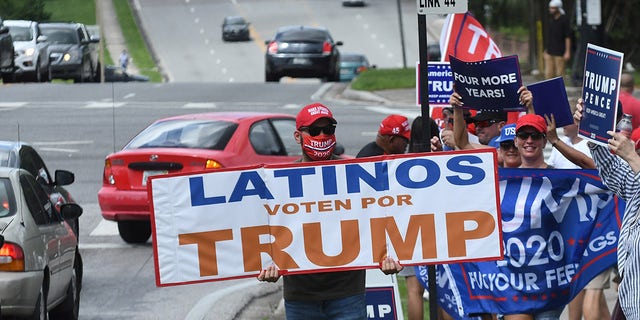 October 10, 2020 - Orlando, Florida, United States - People hold placards after U.S. Vice President Mike Pence addressed supporters at a Latinos for Trump campaign rally at Central Christian University on October 10, 2020 in Orlando, Florida. (Photo by Paul Hennessy/NurPhoto via Getty Images)