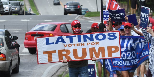 October 10, 2020 - Orlando, Florida, United States - People hold placards after U.S. Vice President Mike Pence addressed supporters at a Latinos for Trump campaign rally at Central Christian University on October 10, 2020 in Orlando, Florida. (Photo by Paul Hennessy/NurPhoto via Getty Images)