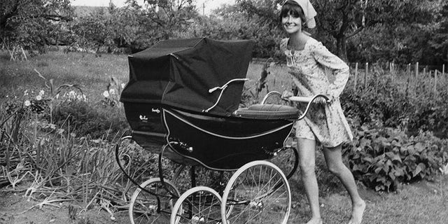 Audrey Hepburn pushing her son Luca, Sean's younger brother, in a carriage.