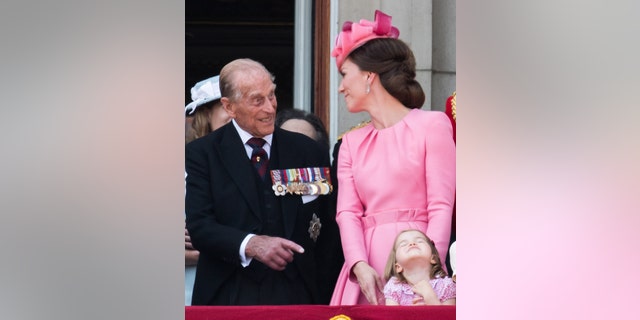 Prince Philip, Duke of Edinburgh, Catherine, Duchess of Cambridge, Princess Charlotte of Cambridge look on from the balcony during the annual Trooping The Colour parade on June 17, 2017, in London, England.