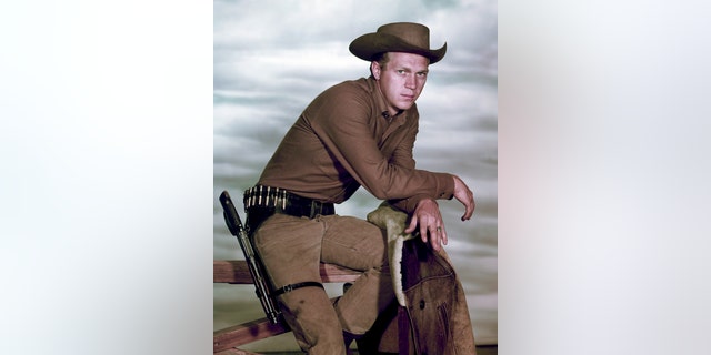 Portrait of American actor Steve McQueen (1930-1980) (as Josh Randall) perched atop a fence in the television series "Wanted: Dead or Alive," late 1950s or early 1960s.