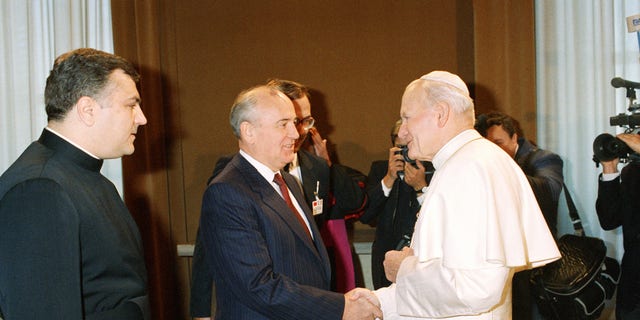 Pope John Paul II shakes hands with Soviet President Mikhail Gorbachev in the first ever meeting between a Kremlin chief and a Pontiff, at the Vatican, Friday, Dec. 1, 1989. (AP Photo/Massimo Sambucetti)