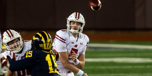 Wisconsin quarterback Graham Mertz (5) throws a pass in the first quarter of an NCAA college football game against Michigan in Ann Arbor, Mich., Saturday, Nov. 14, 2020. (AP Photo/Tony Ding)
