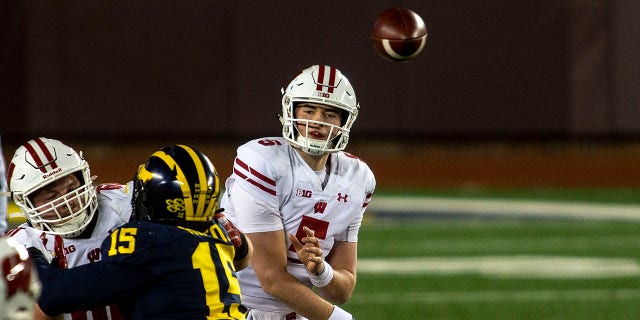 Wisconsin quarterback Graham Mertz (5) throws a pass in the first quarter of an NCAA college football game against Michigan in Ann Arbor, Mich., Saturday, Nov. 14, 2020. (AP Photo/Tony Ding)