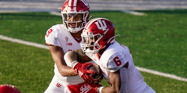 Indiana quarterback Michael Penix Jr. (9) hands off to running back Sampson James (6) during the second quarter of the team's NCAA college football game against Rutgers, Sabato, Ott. 31, 2020, in Piscataway, N.J. (AP Photo/Corey Sipkin)