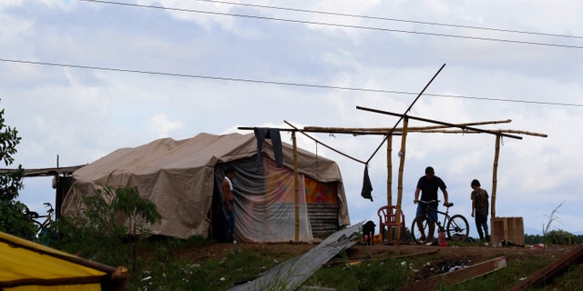 People living under precarious conditions make preparations before Hurricane Iota makes landfall in San Manuel Cortes, Honduras, Monday, Nov. 16, 2020.